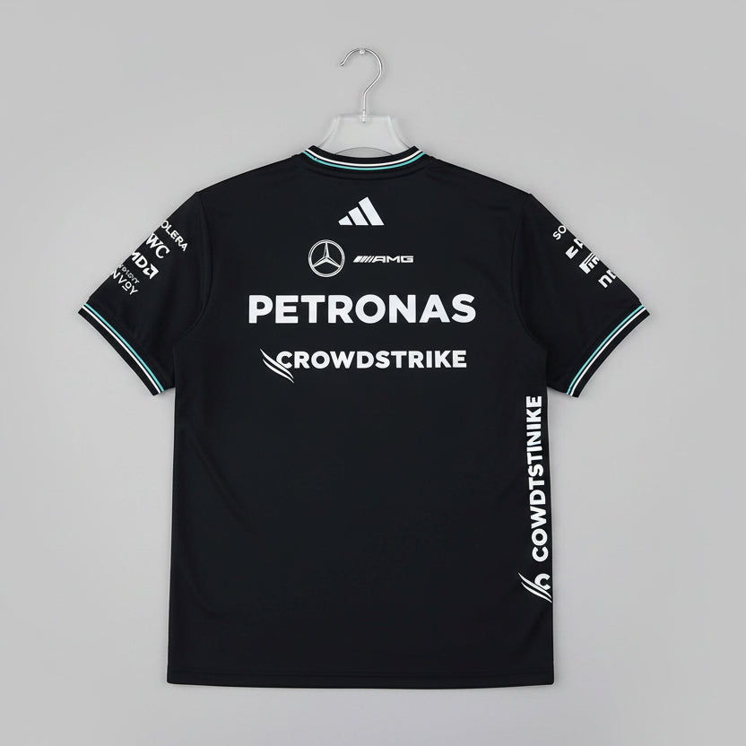 Black sports jersey with Petronas and CrowdStrike logos on a green background