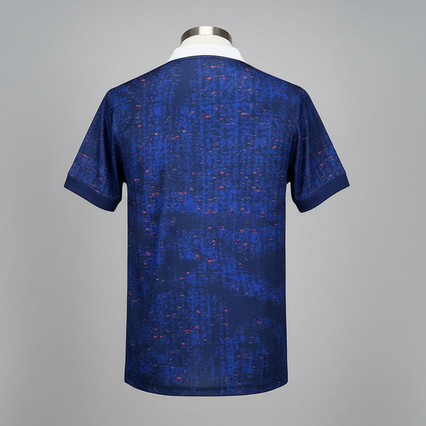Blue patterned polo shirt on a hanger against a wire mesh background