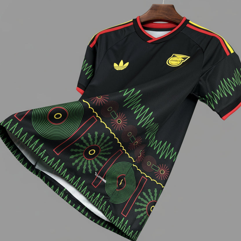 Black sports jersey with green and red patterns on a hanger against a grid background
