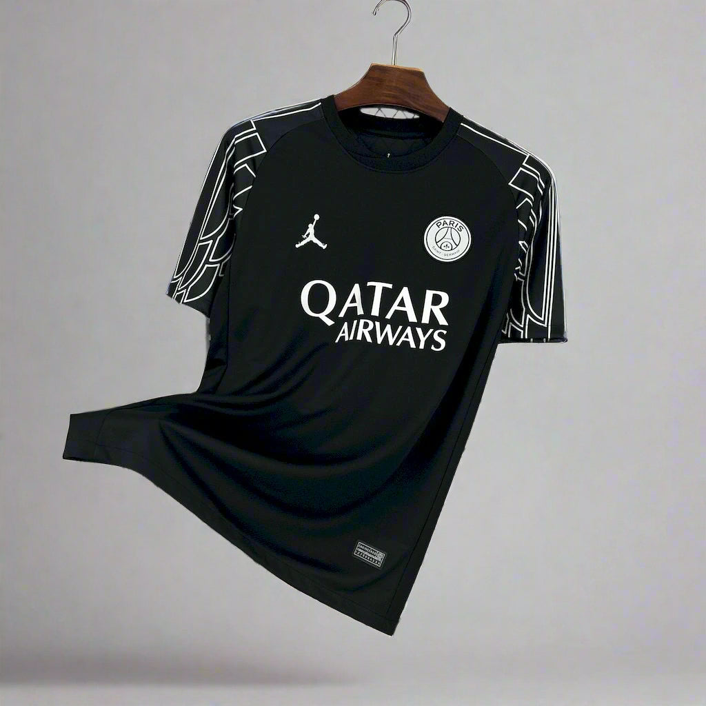 Black sports jersey with Qatar Airways logo on a hanger against a wire mesh background