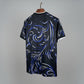 Black t-shirt with blue and white dragon design on a hanger against a grid background