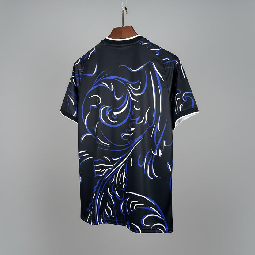 Black t-shirt with blue and white dragon design on a hanger against a grid background