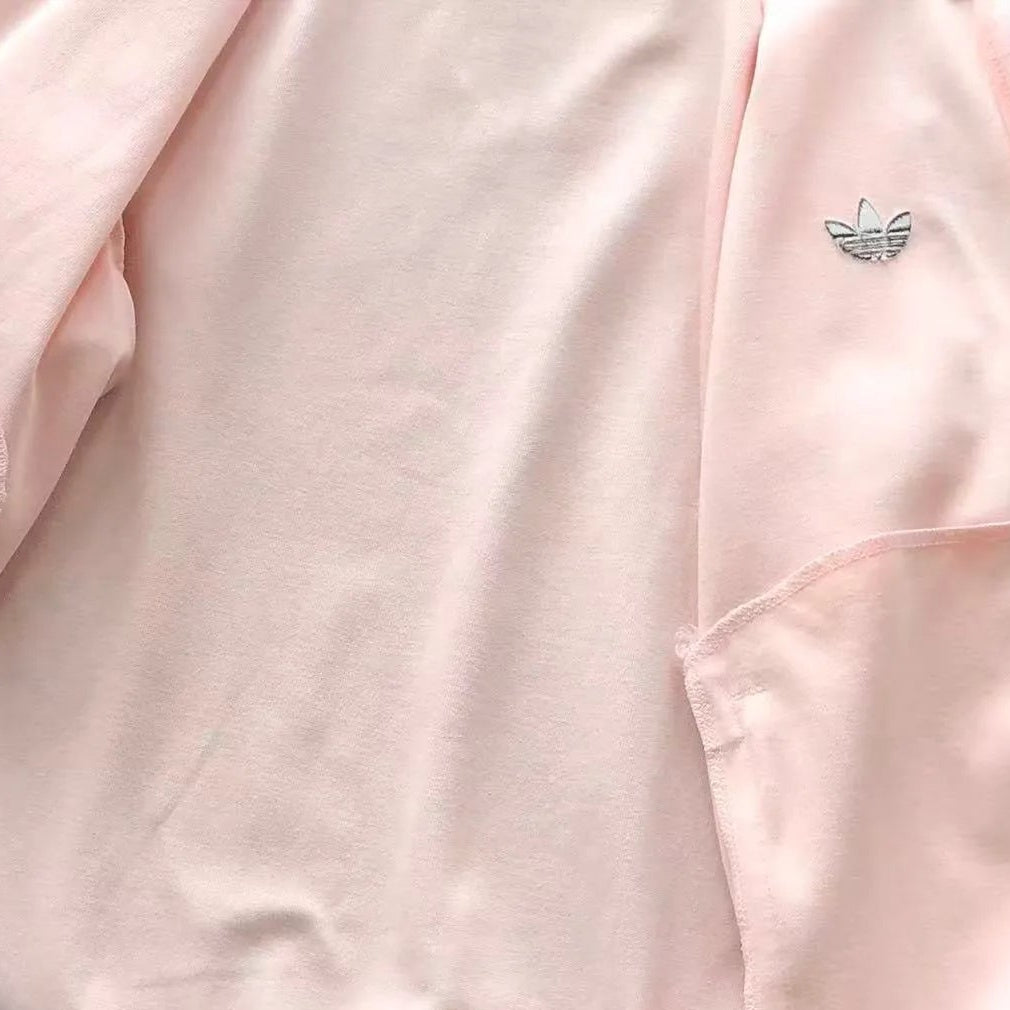 Pink jacket with a brand logo on a wooden floor