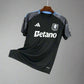 Black sports jersey with Adidas and Betano logos on a hanger against a wire mesh background