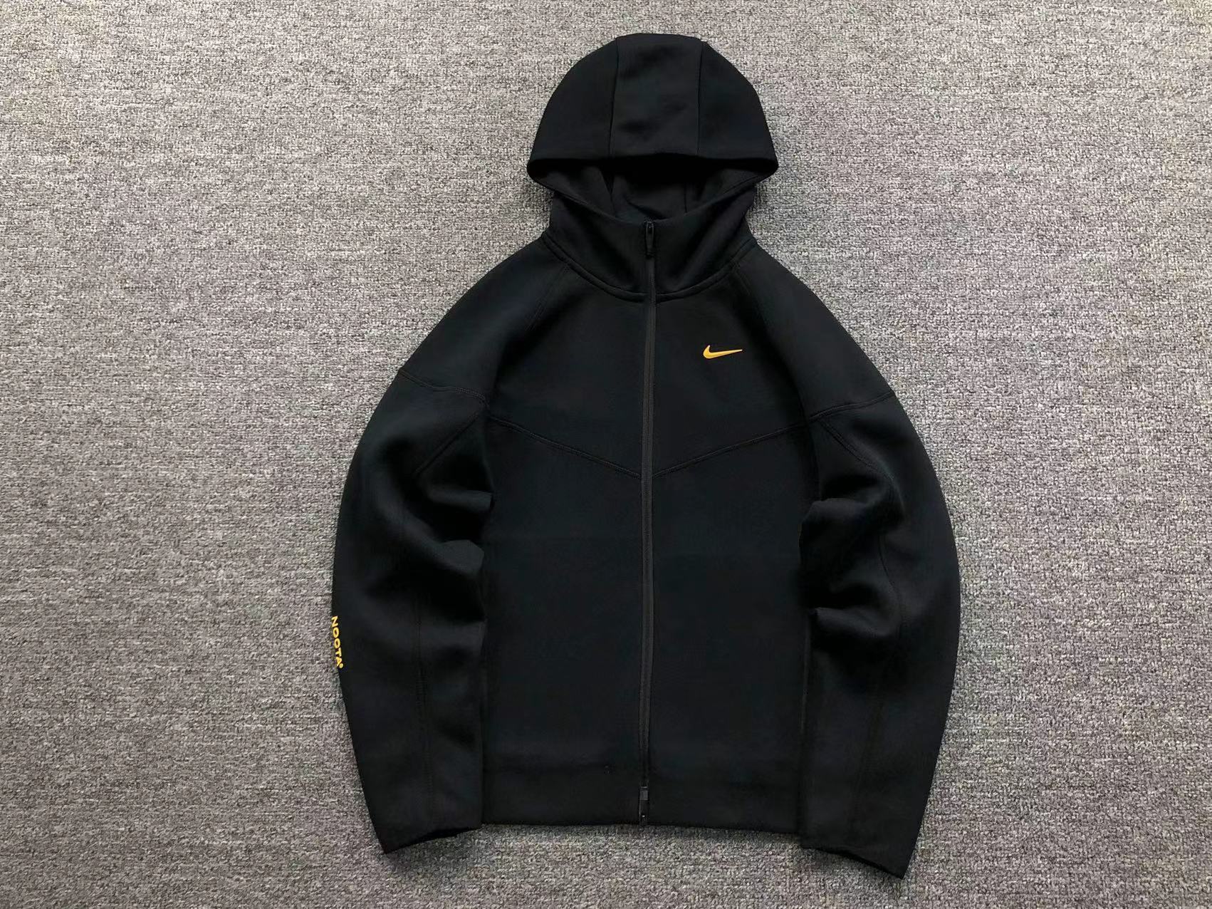 black nike with yellow swoosh