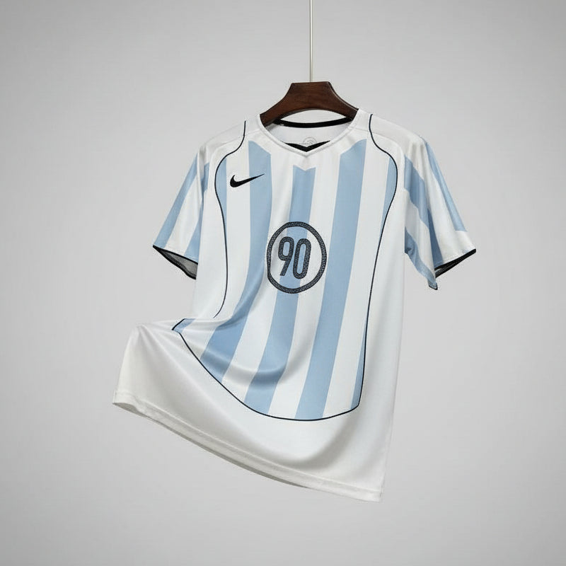 White and blue striped sports jersey with a logo on a hanger against a black metal grid background