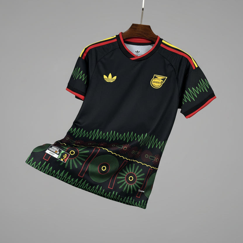 Black sports outfit with green and red accents on a hanger against a grid background